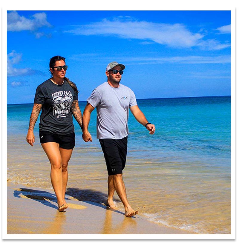 couple walking on macao beach in punta cana, dominican republic